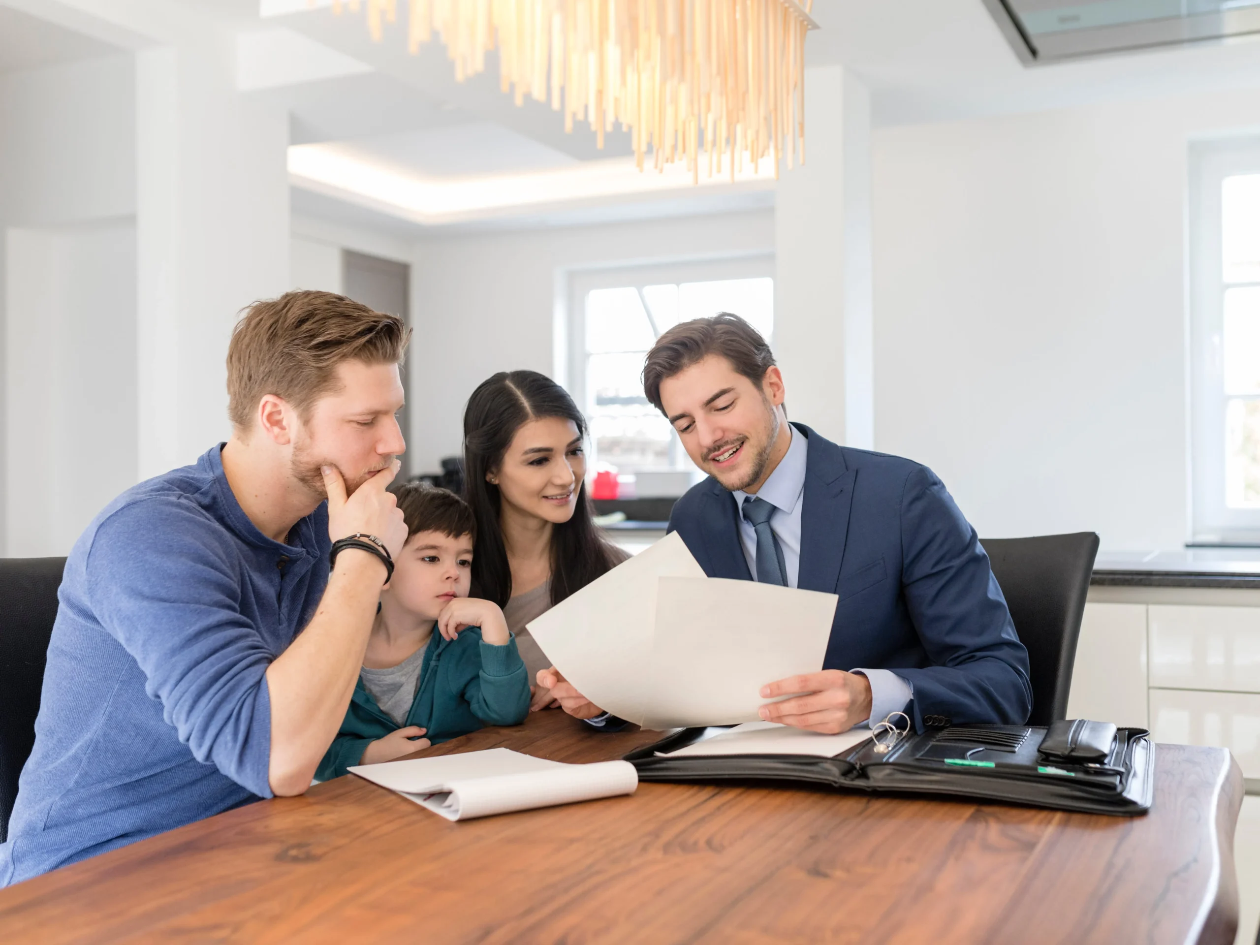 A family reviewing home plans with a Vantage Homes advisor